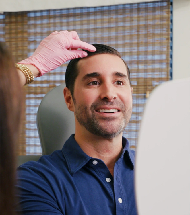 handsome man getting hair restoration treatment