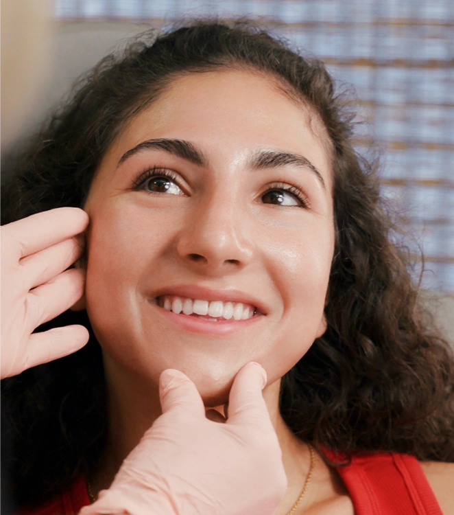 happy beautiful female patient being examined by esthetician